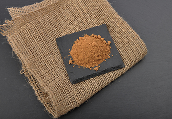 Image showing Carob powder on jute and shale