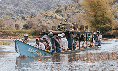 Image showing overloaded boat taxi in countryside on river