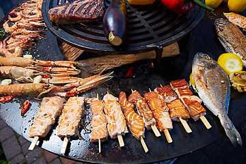 Image showing Grilled fresh seafood: prawns, fish, octopus, oysters food background Barbecue Cooking BBQ