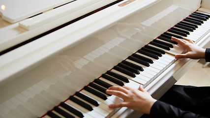 Image showing Womans hands on the keyboard of the piano closeup