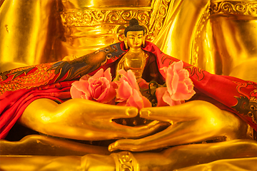 Image showing Small Buddha Sakyamuni statue in hands of large