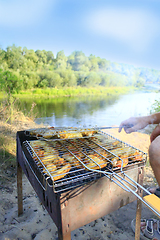 Image showing man cooks barbecue from hen's meat 