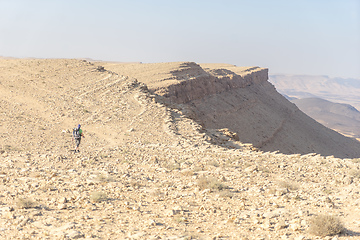 Image showing Hiking tourist in desert trek adventure