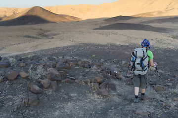 Image showing Hiking tourist in desert trek adventure