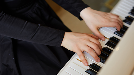 Image showing Womans hands on the keyboard of the piano closeup