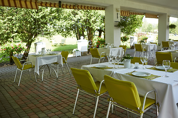 Image showing terrace summer cafe with tables and chairs for people, an empty institution for recreation, nobody