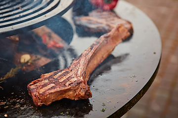 Image showing beautifully seared tomahawk steak, medium rare to rare