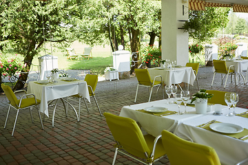 Image showing terrace summer cafe with tables and chairs for people, an empty institution for recreation, nobody