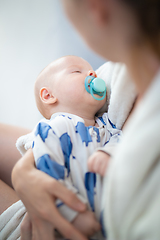 Image showing Young mother is holding her little baby boy.