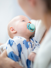 Image showing Young mother is holding her little baby boy.