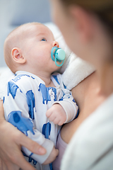 Image showing Young mother is holding her little baby boy.