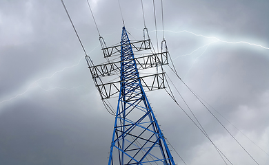 Image showing High voltage tower against the cloudy sky with lightning strike