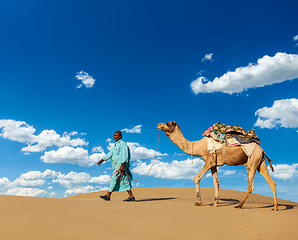 Image showing Cameleer (camel driver) with camels in Rajasthan, India