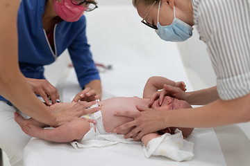 Image showing Baby beeing vaccinated by pediatrician in presence of his mother. Preventive vaccination against Diphtheria, whooping cough, tetanus, hepatitis, haemophilus influenzae, pneumococcus, poliomyelitis