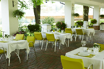 Image showing terrace summer cafe with tables and chairs for people, an empty institution for recreation, nobody