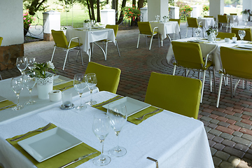 Image showing terrace summer cafe with tables and chairs for people, an empty institution for recreation, nobody