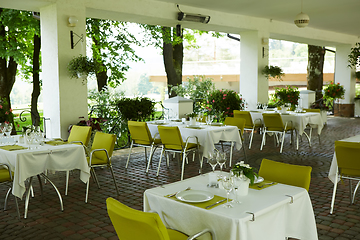 Image showing terrace summer cafe with tables and chairs for people, an empty institution for recreation, nobody