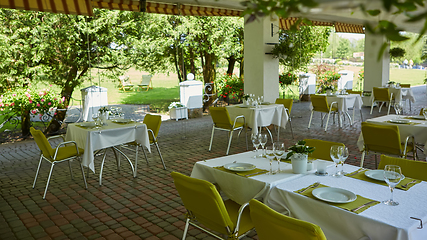 Image showing terrace summer cafe with tables and chairs for people, an empty institution for recreation, nobody