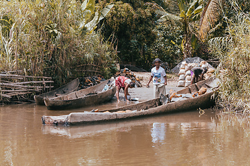 Image showing Malagasy woman washes dishes, Madagascar countryside