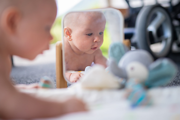 Image showing Beautiful shot of mirror reflectiona of cute baby boy playing with toys.