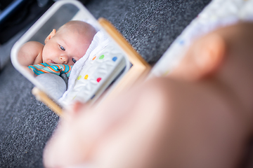 Image showing Beautiful shot of mirror reflectiona of cute baby boy playing with toys.