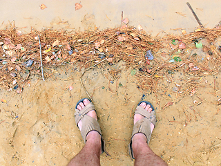 Image showing feet of the traveller standing on the sand