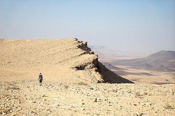 Image showing Hiking tourist in desert trek adventure