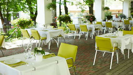 Image showing terrace summer cafe with tables and chairs for people, an empty institution for recreation, nobody