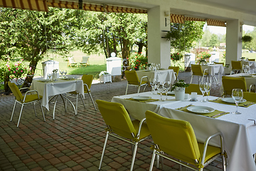 Image showing terrace summer cafe with tables and chairs for people, an empty institution for recreation, nobody