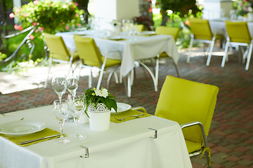 Image showing terrace summer cafe with tables and chairs for people, an empty institution for recreation, nobody