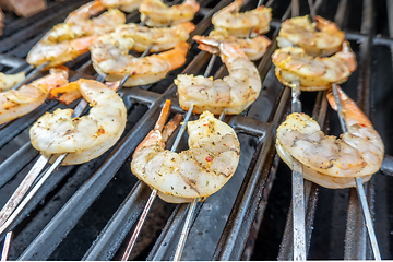 Image showing jumbo shrimp on skewers on a grill for dinner