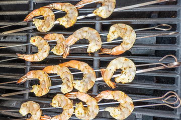 Image showing jumbo shrimp on skewers on a grill for dinner