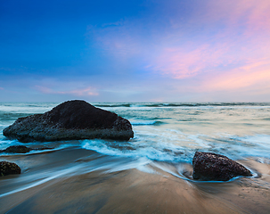 Image showing waves and rocks on beach of sunset