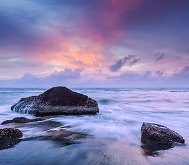 Image showing Waves and rocks on beach of sunset