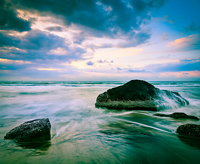 Image showing Waves and rocks on beach of sunset