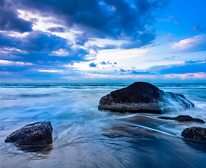 Image showing Waves and rocks on beach of sunset