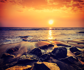 Image showing Waves and rocks on beach of sunset