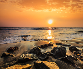 Image showing Waves and rocks on beach of sunset