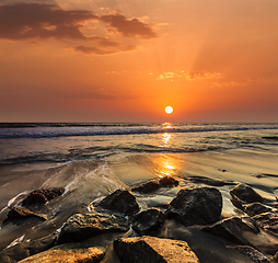 Image showing Waves and rocks on beach of sunset