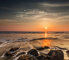 Image showing Waves and rocks on beach of sunset