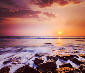 Image showing Waves and rocks on beach of sunset