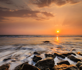 Image showing Waves and rocks on beach of sunset