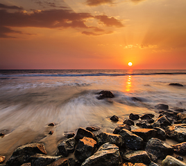 Image showing Waves and rocks on beach of sunset