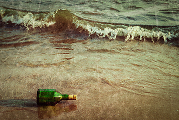 Image showing Message bottle on beach in waves