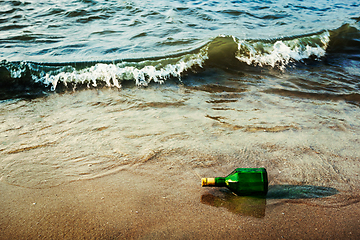 Image showing Message bottle on beach in waves