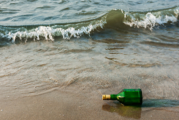 Image showing Message bottle on beach in waves