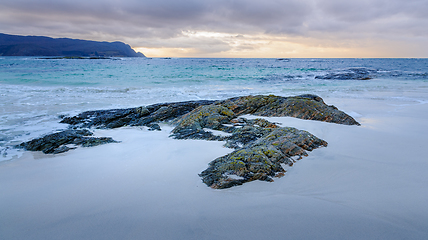 Image showing rock formations coming up through the sand on the beach