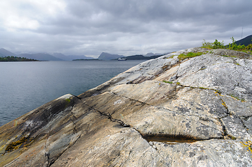 Image showing rock formations by the sea and boats passing by