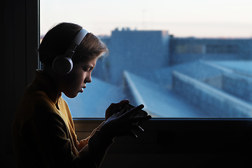 Image showing Teenage boy in white headphones