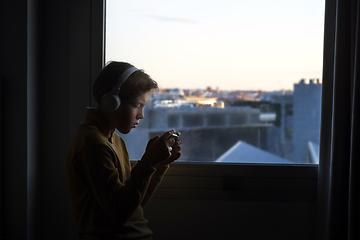 Image showing Teenager playing near the window